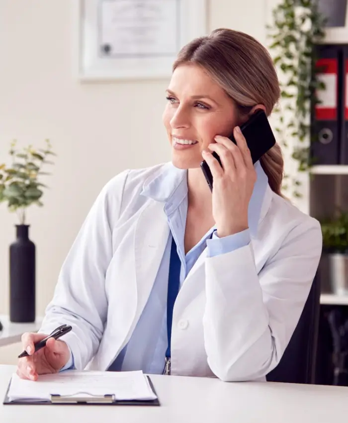 Smiling doctor on a call, ready to answer your questions